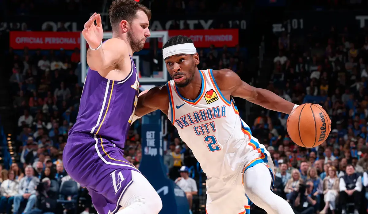 A-basketball-player-from-the-Oklahoma-City-Thunder-dribbles-past-a-defender-from-the-opposing-team-during-a-game.___