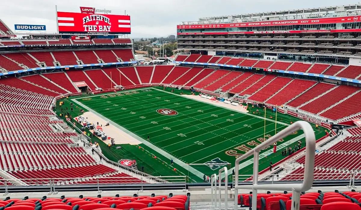 A-wide-view-of-Levis-Stadium-showing-empty-red-seats-and-a-green-football-field-with-San-Francisco-49ers-branding-before-a-game.___