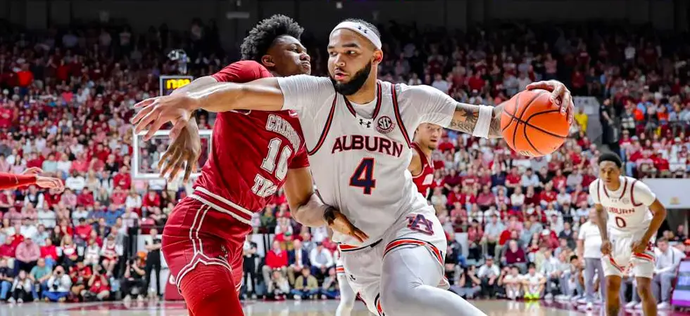 Two-basketball-players-in-a-march-madness-game-fighting-the-ball